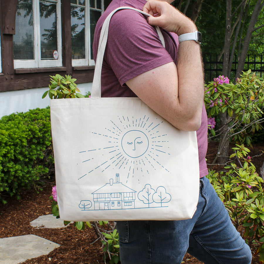 This cream tote bag's design is in a bright blue color.