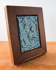 The Framed Nativity Tile sits at an angle, showcasing the glossy nature of the glaze.