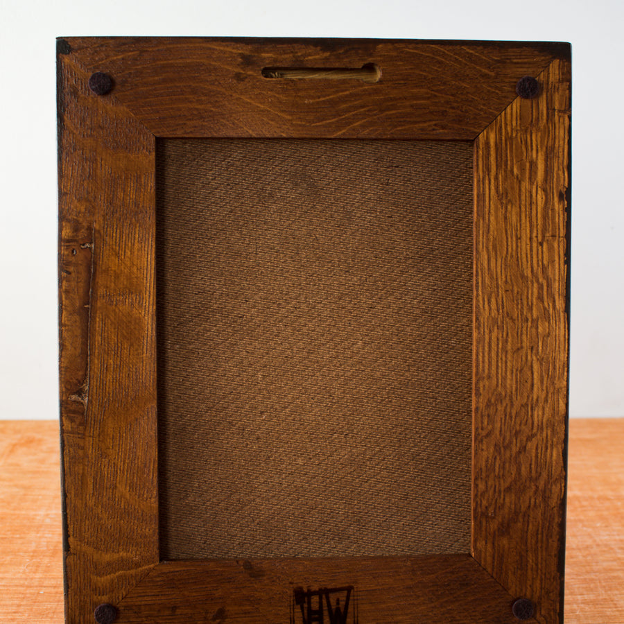 The back of the framed tile includes four small felt pads to protect your walls and there is a burned logo reading "HW" - for Henige Woodworks, the maker of this frame. The back of the tile is covered with a darker wood backing.