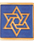 The raised portion of this tile - the star and border - are scraped, giving them a toasty orange color while the background is a matte bright blue.