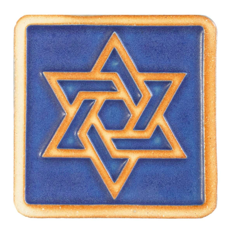 The raised portion of this tile - the star and border - are scraped, giving them a toasty orange color while the background is a matte bright blue.