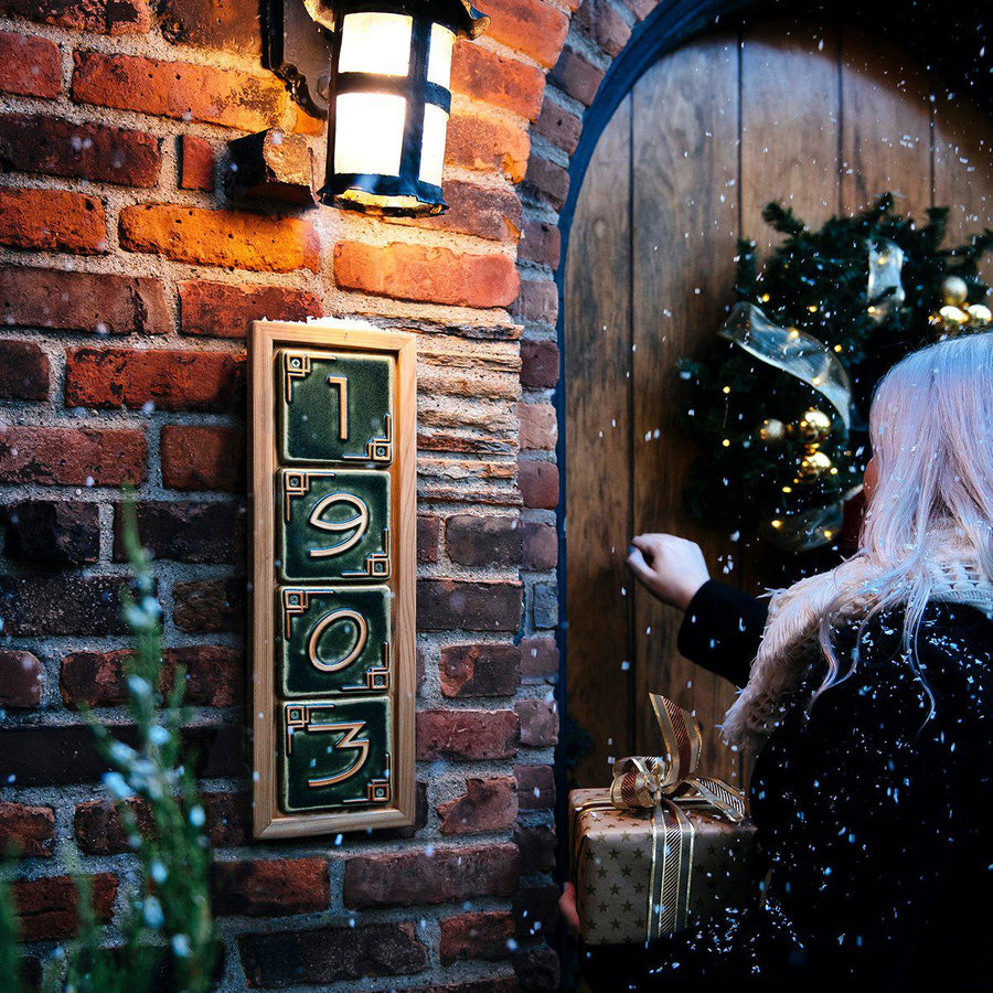 The wooden frame is attached to a brick home on a wintery day as a woman knocks on the front door.