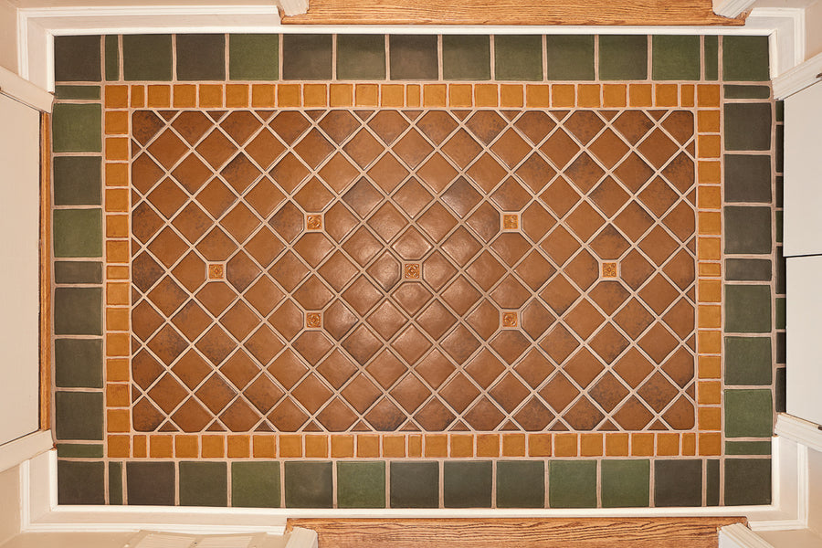 Bayleaf glazed tiles make up the trim of this foyer detail shot with a warm, chestnut glazed center.