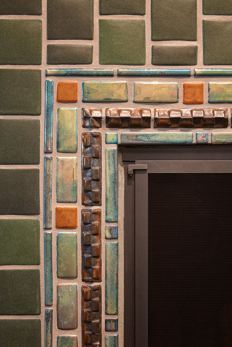 Corner shot of the iridescent glazed accent center of the bayleaf and chestnut fireplace.