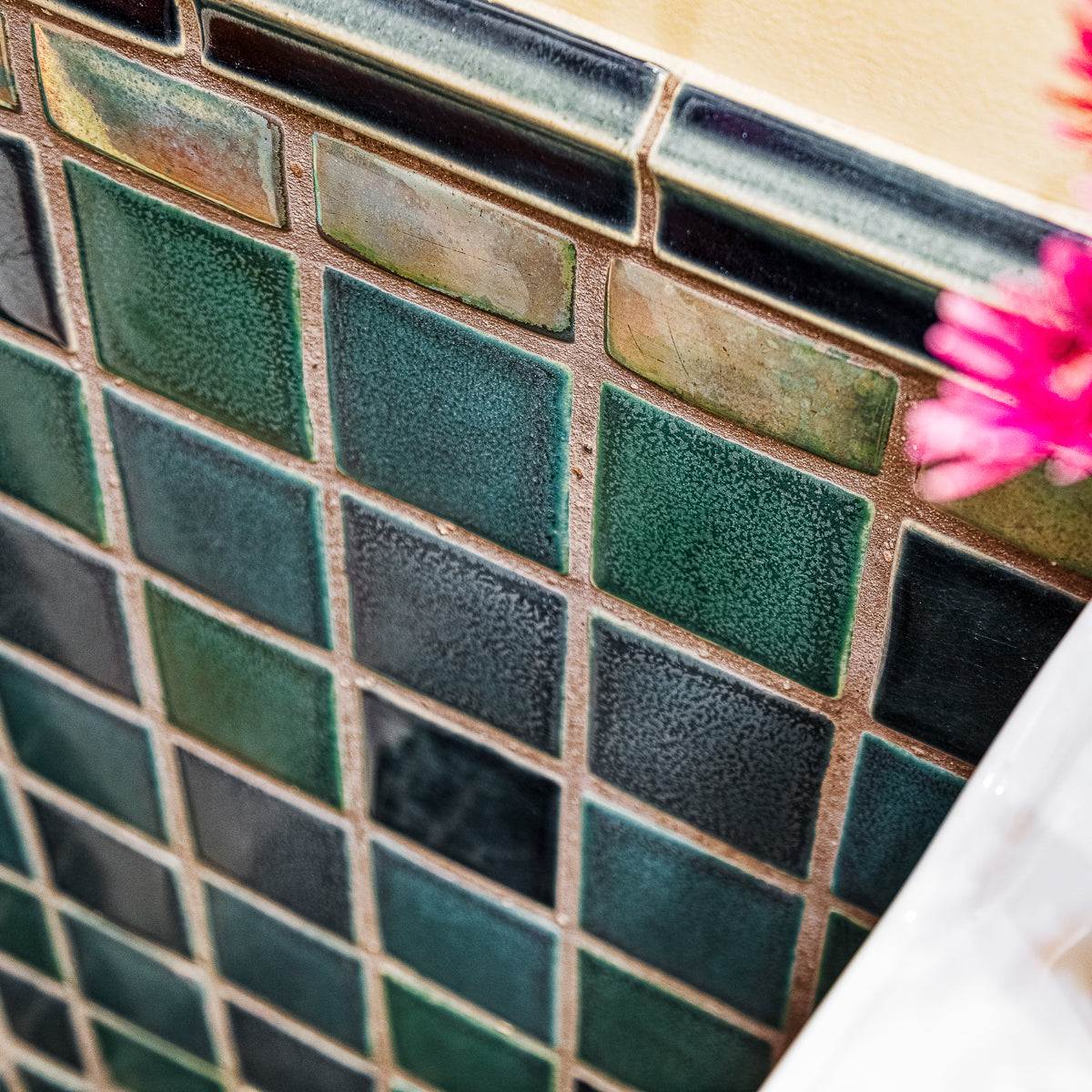 Details of the blue, green, and "Aurora" iridescent 4x4 field tiles and custom trim.