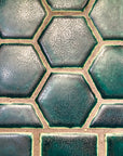 Details of the blue hexagonal and "half-hex" tiles on the bathroom floor. 