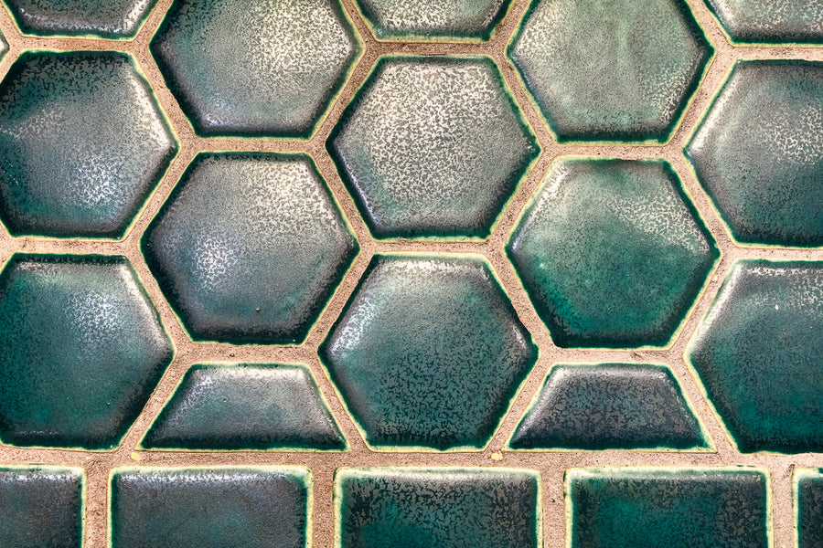 Details of the blue hexagonal and "half-hex" tiles on the bathroom floor. 