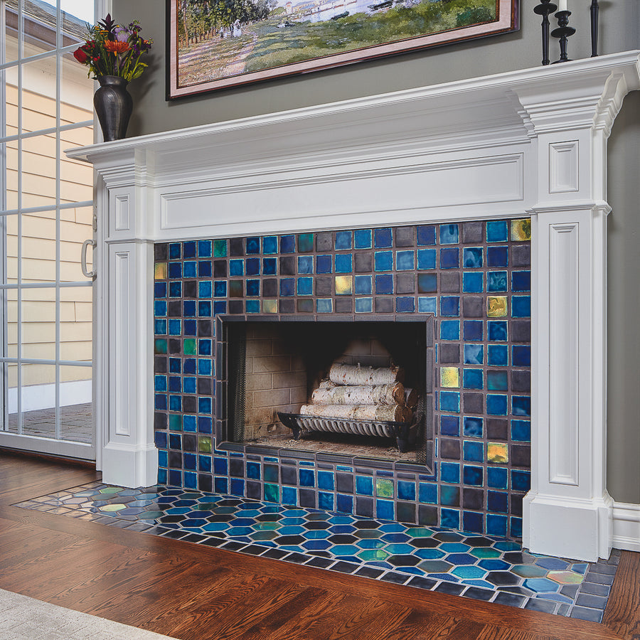 This fireplace features Iridescent tile accents along with a mix of complementary blue and charcoal tones. 