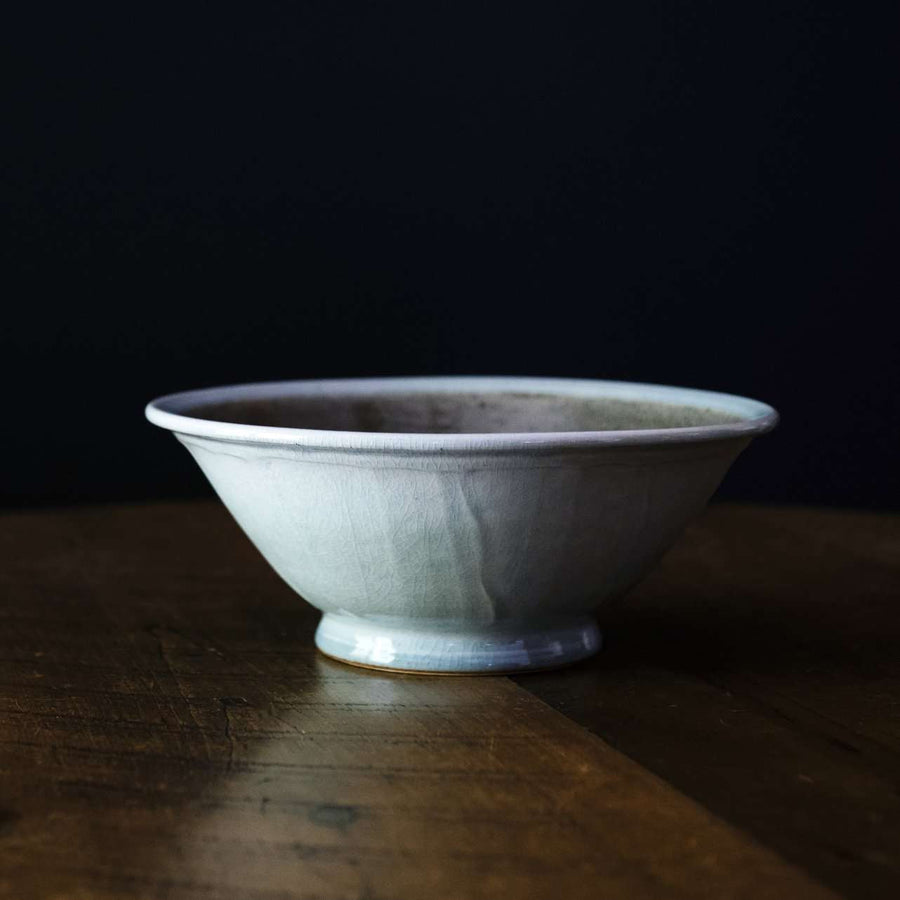 The Birch Harvest Bowl sits on a dark wood table.