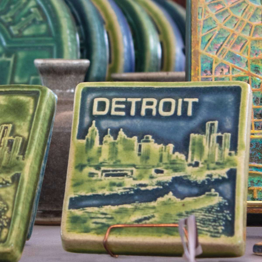 This two-tone Detroit Skyline tile is featured in the Lime/Lagoon color palette. The sky and water are in the matte blue Lagoon glaze and the skyline, boat, and word is in the matte bright light green Lime glaze.