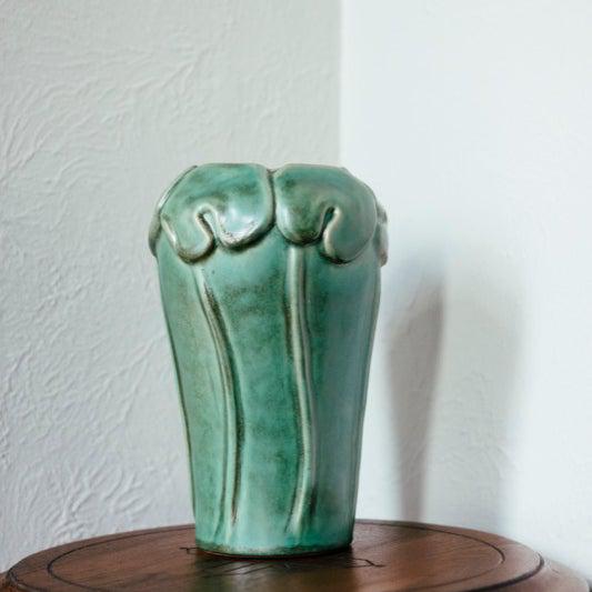 The Lotus Vase features the matte mottled green of the Sorrel Glaze.