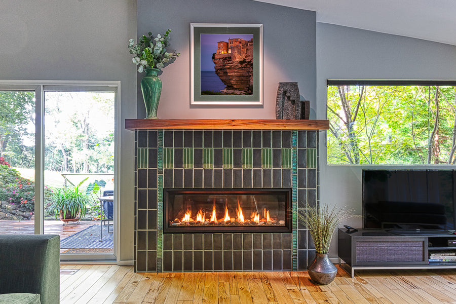 Straight on view of a custom Pewabic fireplace incorporating Midcentury Modern design elements with an Aurora Iridescent Saarinen-inspired tile border.