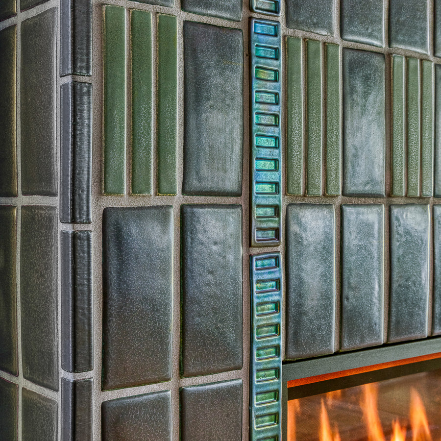 Detail photo of the tile texture. You can see the light reflecting off of the Gunmetal, Rain, and Aurora Iridescent glazed tiles.
