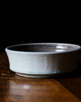 This Mod Bowl features the glossy pale blue-gray Frost glaze. A close-up of the Frost glaze shows crazing on its surface- this gives the appearance of tiny cracks on the glaze's surface.