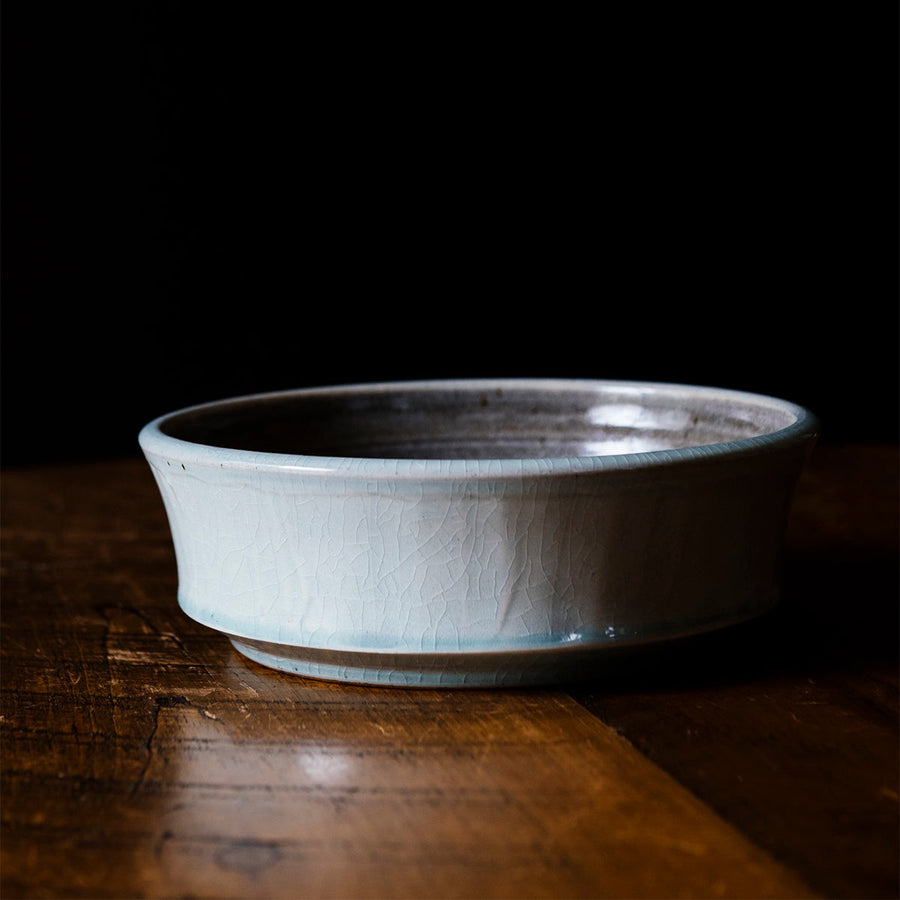 This Mod Bowl features the glossy pale blue-gray Frost glaze. A close-up of the Frost glaze shows crazing on its surface- this gives the appearance of tiny cracks on the glaze's surface.