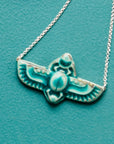 This scarab necklace features the matte turquoise Pewabic Blue glaze.