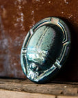 This paperweight has a mix of shiny metallic and matte glaze.