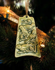 The ceramic Four Calling Birds Ornament hangs from a lighted Christmas Tree.