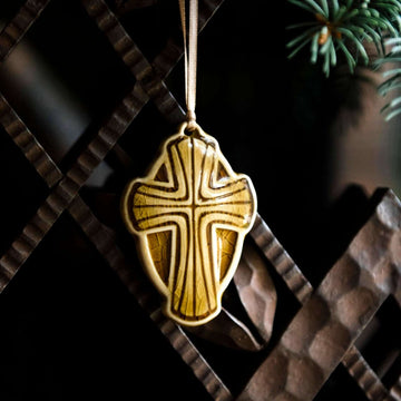 The Cross Ornament features a cross with a halo-like oval behind it. This ornament features the deep golden Honey Gloss glaze.