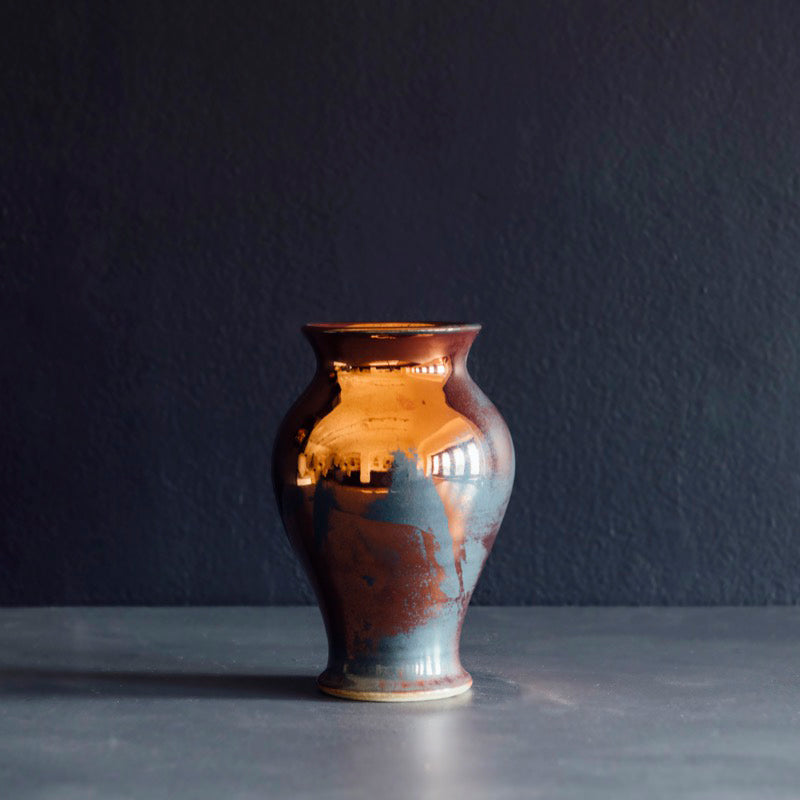 The Classic Vase starts with a small diameter at its base that gradually gets larger until it contracts again near the top with a slightly wider lip. The sides of this vase are completely smooth.