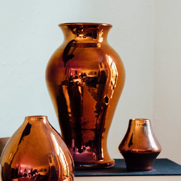 This Copper Iridescent Classic Vase has some rosy pinkish colors at its base that transform into a bright copper color near the top.