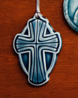 This Cross Ornament features the glossy deep blue Ocean glaze.