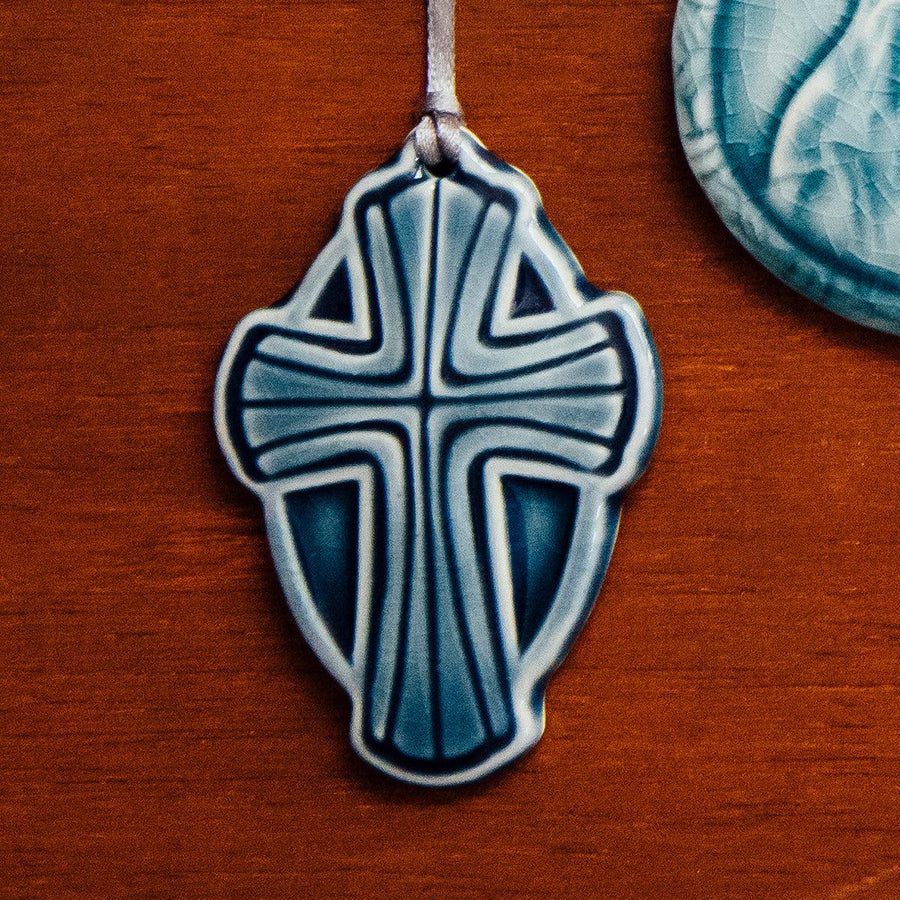 This Cross Ornament features the glossy deep blue Ocean glaze.