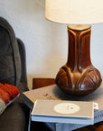 This Celtic Lamp is featured in the matte brownish-red tones of the Cinnamon glaze with its cream lampshade.