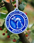 The round Michigan Ornament features the state's two peninsulas surrounded by a border with the words "enjoy the beauty and the bounty, Michigan" written around the circular edge.