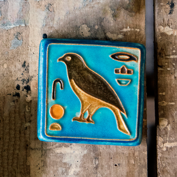 First designed in the 1920s, this hand-painted 3x3 tile depicts the bird hieroglyph Horus, the falcon-headed God of Light.