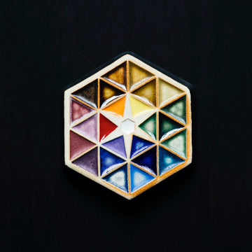 The Hex Paperweight sits on a dark black background.