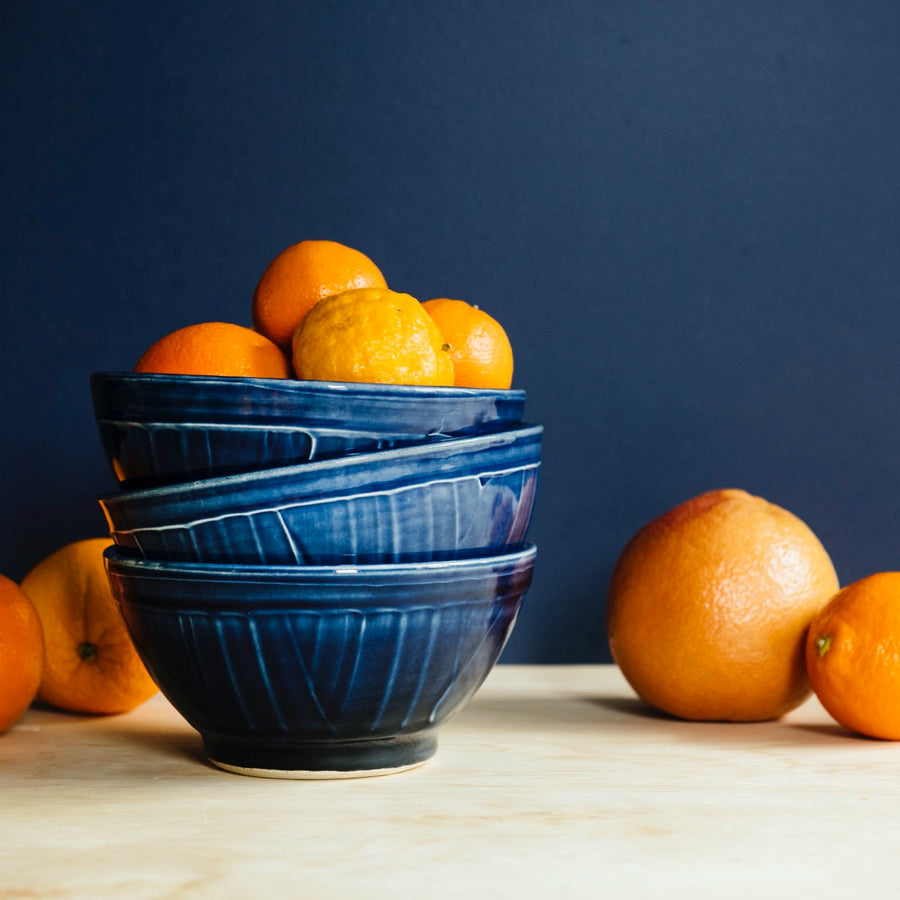 The Classic bowls are rounded with slip details that give the sides of the bowl an organic stripe pattern. This bowl features the glossy deep dark blue Midnight glaze.
