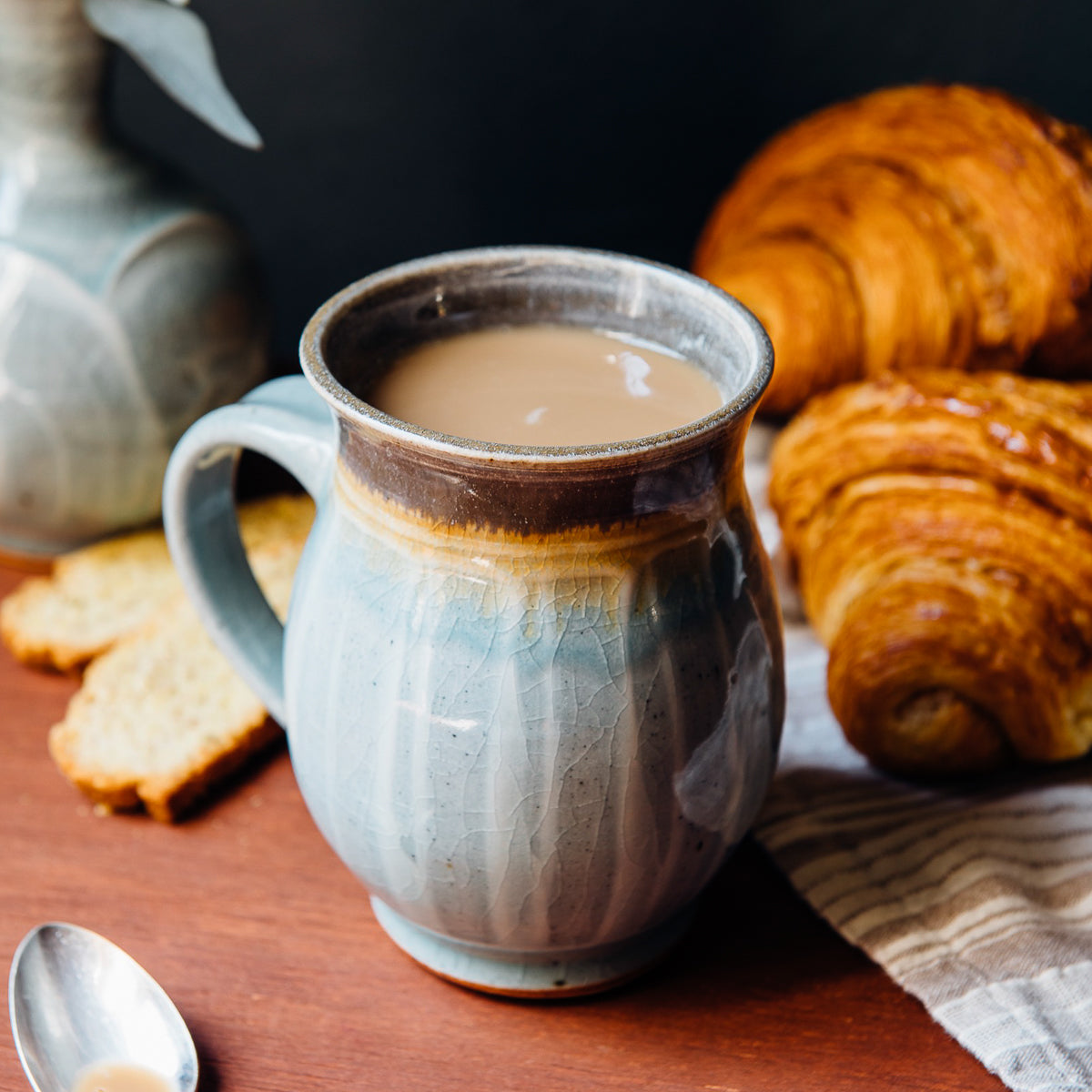 This mug features the glossy pale blue-gray Frost glaze. The lip of the mug is gray.