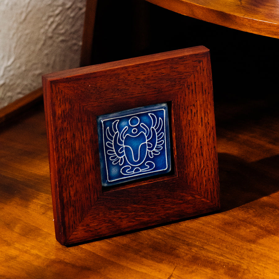 The Framed Scarab Tile in Lake Superior glaze.