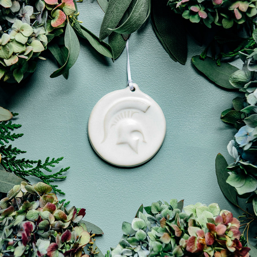This ornament features the bright white matte Alabaster glaze with a skinny white ribbon..