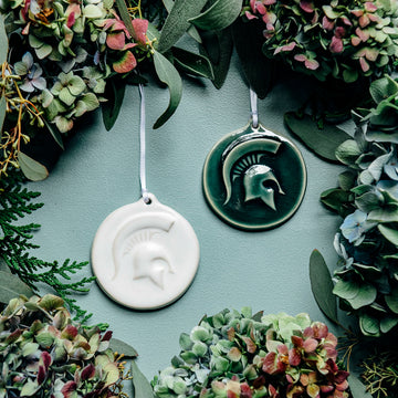 These round, disc-like ornaments feature an MSU Spartan helmet with a large crest.
