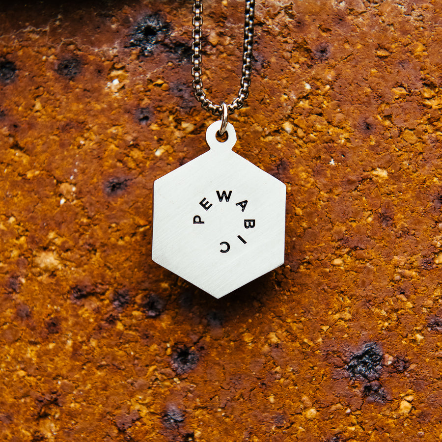 The back of the Hex medallion features the Pewabic logo stamped into the metal's surface.