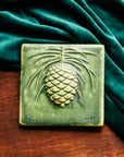 This Ceramic 6X6 Pine Cone Tile is shown in the Leaf green glaze.