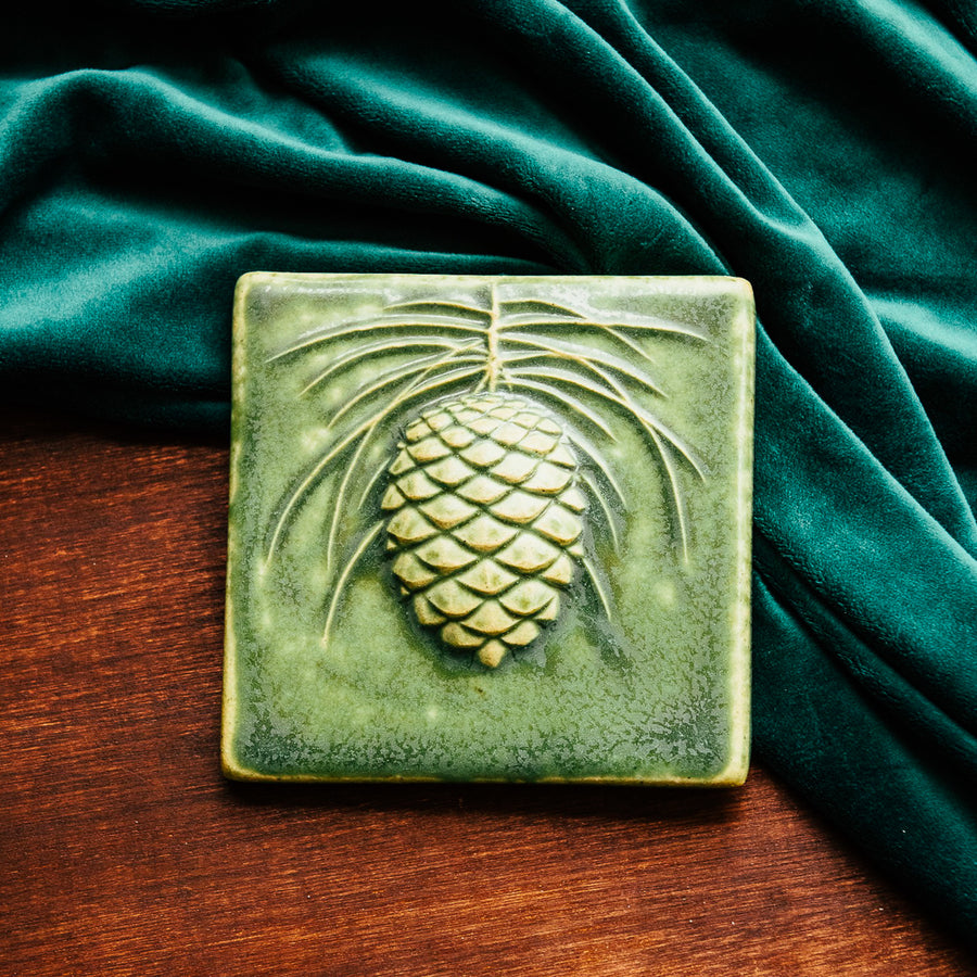 This Ceramic 6X6 Pine Cone Tile is shown in the Leaf green glaze.