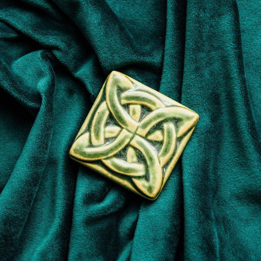 The Lover's Knot Tile features a central ring with four corner loops weaving around the ring from the corners to the center of the tile.