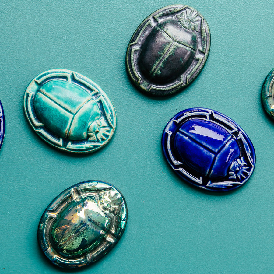 These high relief paperweights feature a scarab beetle with arms tucked in to create a perfect oval shape. 