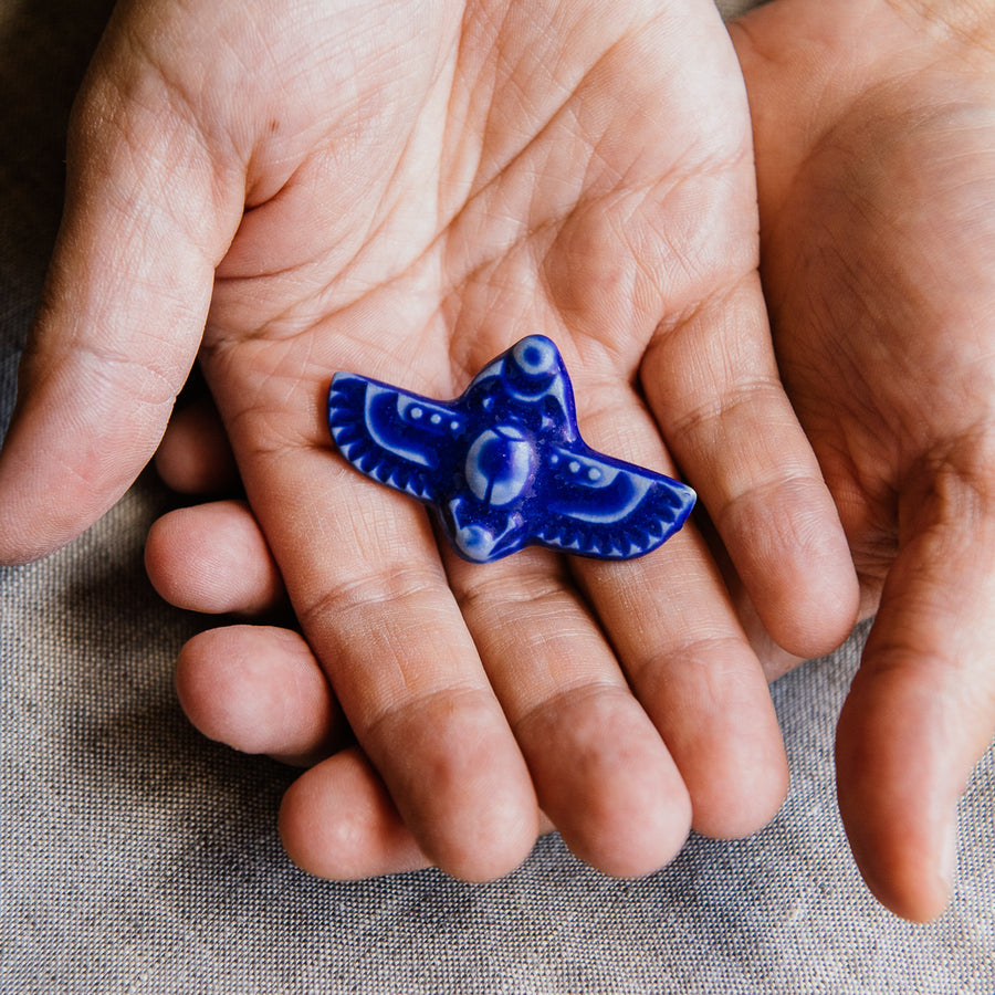 This high relief ceramic pin features a stylized scarab beetle with outstretched wings. The Scarab Pin featured is in a thick, almost opaque lively true-blue “Cobalt” glaze.