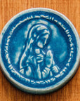 This ceramic Blessed Virgin Mary Tile is glazed in a matte blue Peacock glaze.