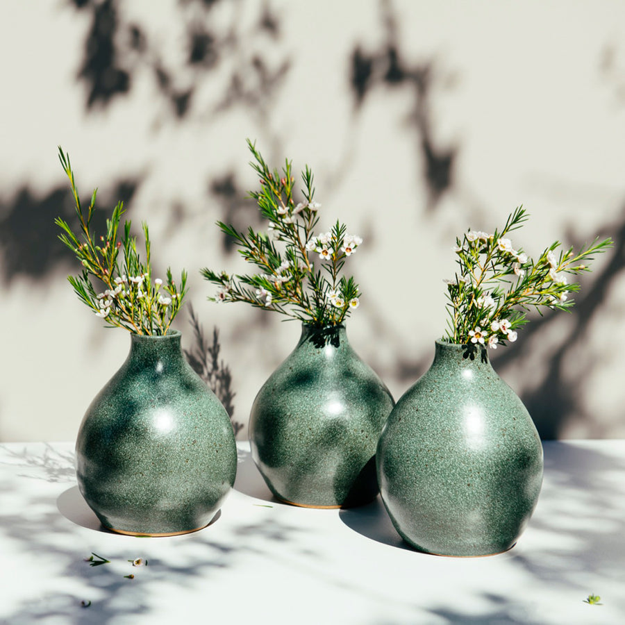 Three Teardrop vases sit together. They feature the matte mottled Greenstone vase that contains some sparse brown speckling.