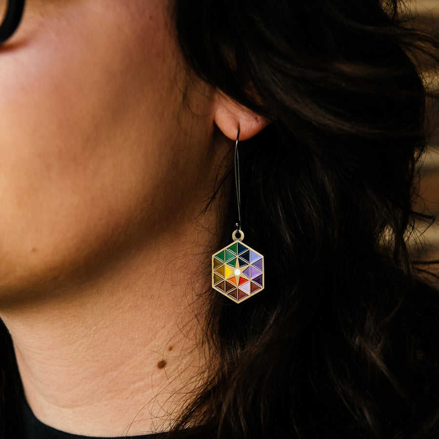 A detail of the earring shows the interlocking triangles on the Hex make a starburst shape near the center.