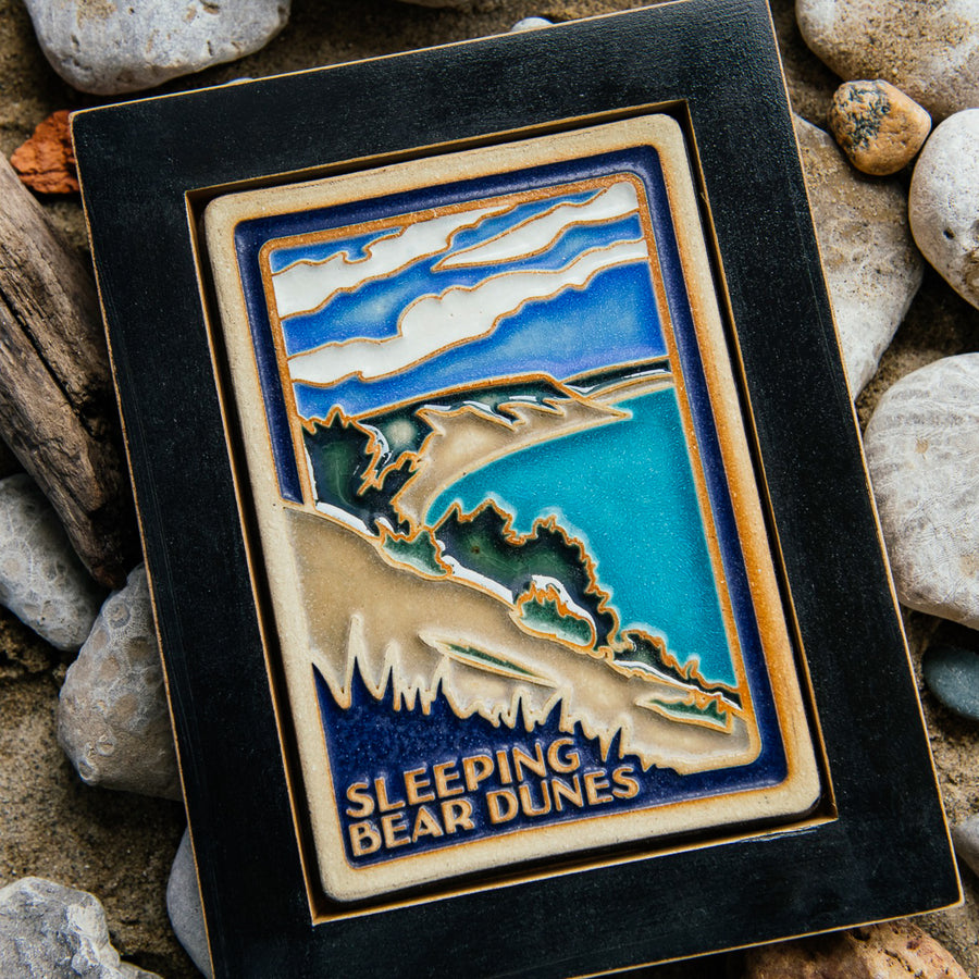 The Hand-painted Sleeping Bear Dunes Tile in a black frame.