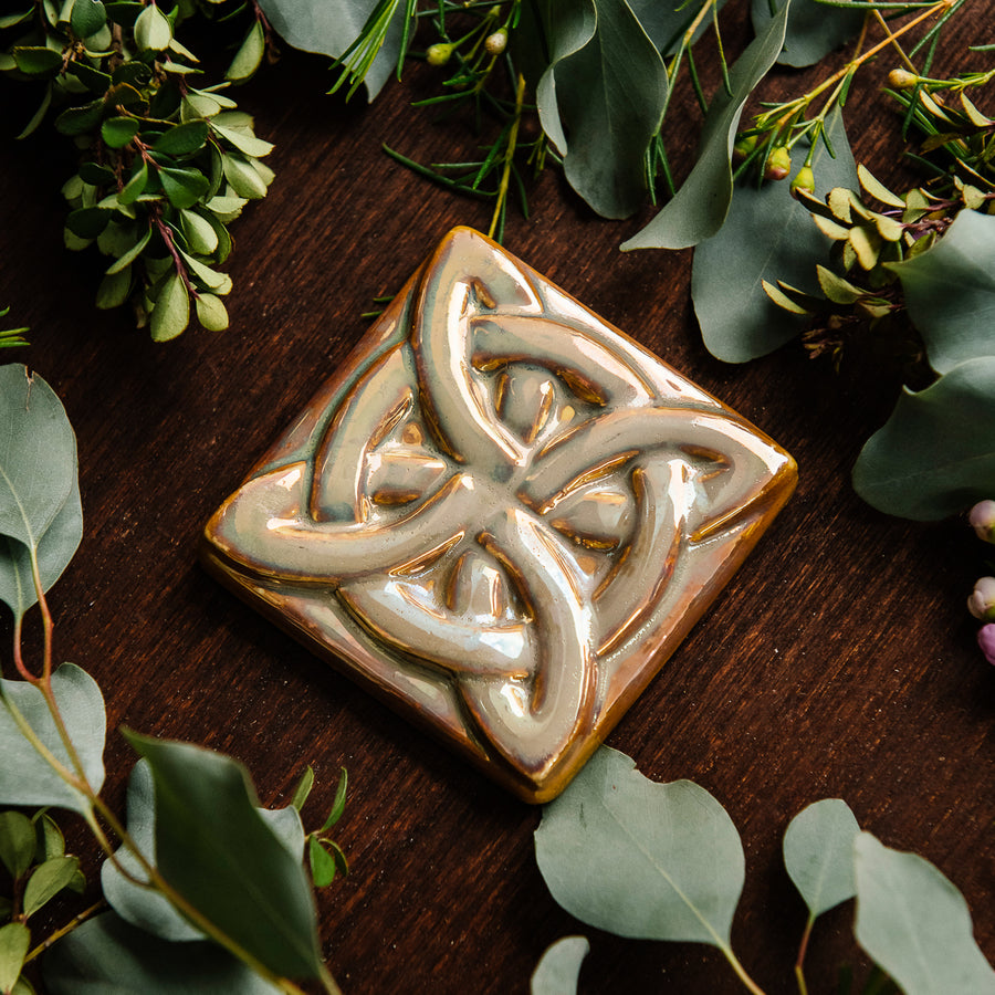 The Lover's Knot Tile features a central ring with four corner loops weaving around the ring from the corners to the center of the tile.