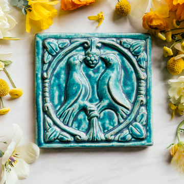 This Lovebirds Tile features the matte turquoise Pewabic Blue glaze.