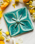 This Geo Flower tile features the matte turquoise Pewabic Blue glaze.
