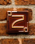 The Craftsman style ceramic 2 address number is in the satin reddish brown Carmine glaze option.